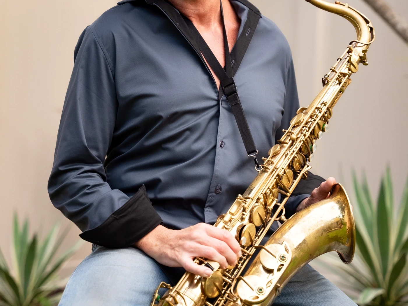 Close-up of David Maxx holding his tenor saxophone